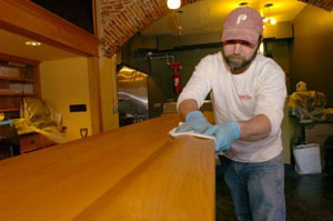 Andrew Desiderio doing finish carpentry work on the bar at The Station Tap Room in Downingtown, PA